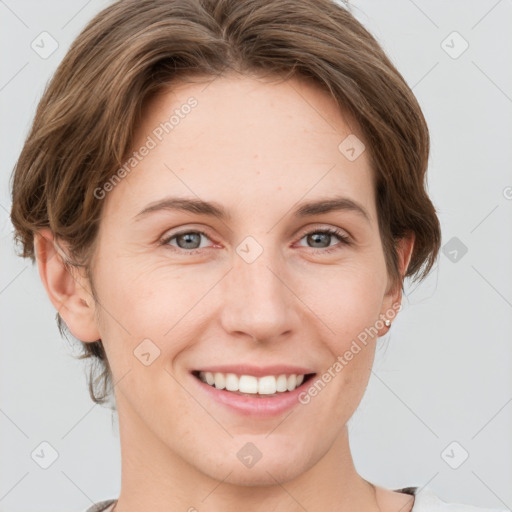 Joyful white young-adult female with short  brown hair and grey eyes