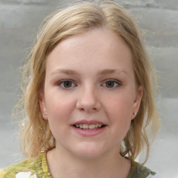 Joyful white child female with medium  brown hair and blue eyes