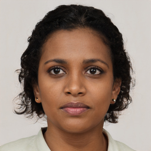 Neutral black young-adult female with long  brown hair and brown eyes