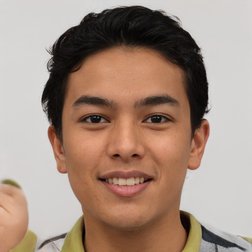 Joyful asian young-adult male with short  brown hair and brown eyes