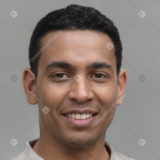 Joyful latino young-adult male with short  brown hair and brown eyes