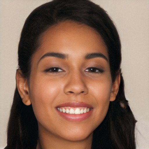 Joyful latino young-adult female with long  black hair and brown eyes