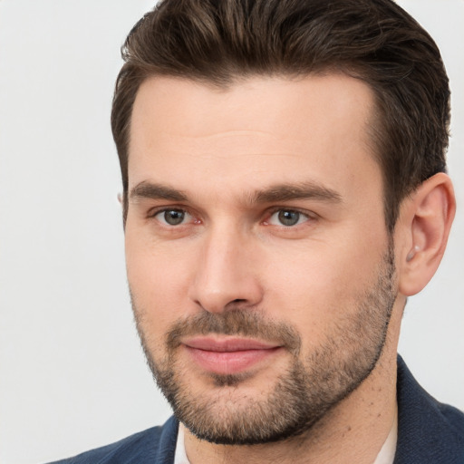 Joyful white young-adult male with short  brown hair and brown eyes