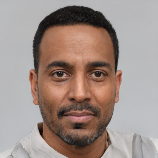 Neutral black adult male with short  black hair and brown eyes