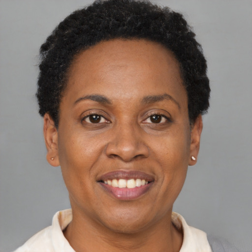 Joyful black adult female with short  brown hair and brown eyes