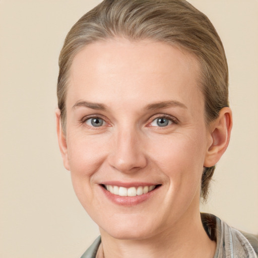 Joyful white adult female with short  brown hair and grey eyes