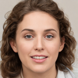 Joyful white young-adult female with medium  brown hair and green eyes