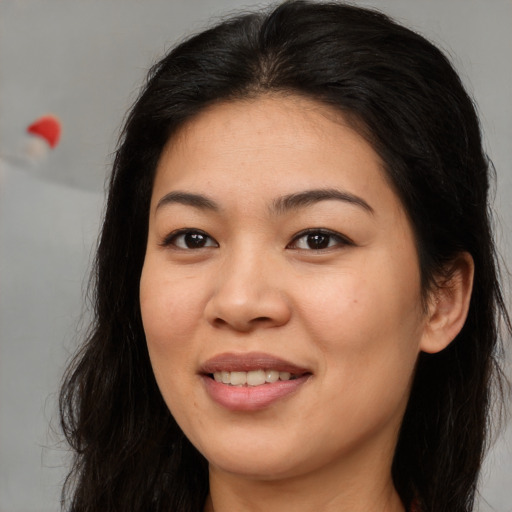 Joyful asian young-adult female with long  brown hair and brown eyes