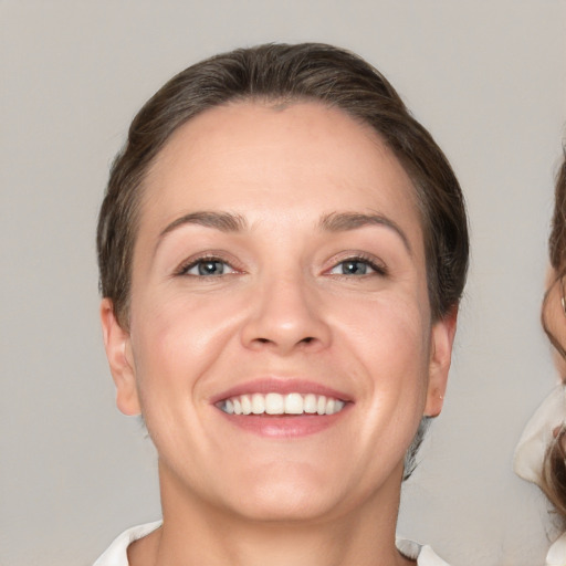 Joyful white adult female with medium  brown hair and brown eyes