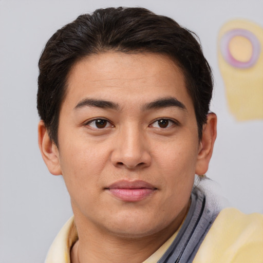 Joyful asian young-adult male with short  brown hair and brown eyes