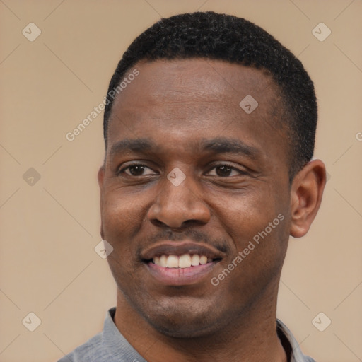 Joyful black young-adult male with short  black hair and brown eyes