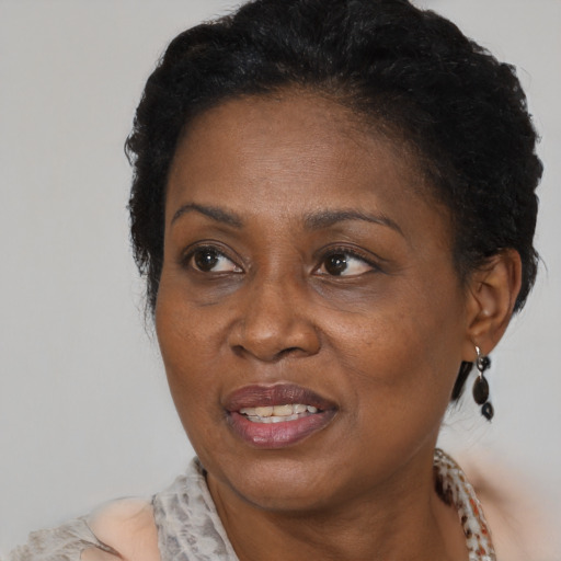 Joyful black adult female with short  brown hair and brown eyes