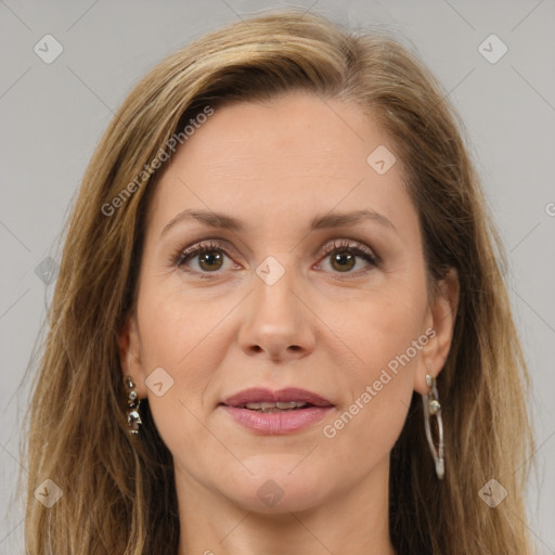 Joyful white adult female with long  brown hair and brown eyes