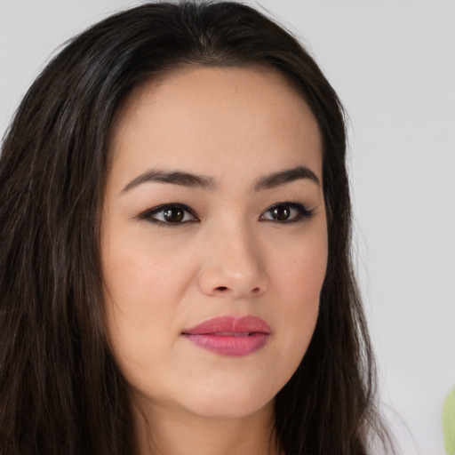 Joyful asian young-adult female with long  brown hair and brown eyes