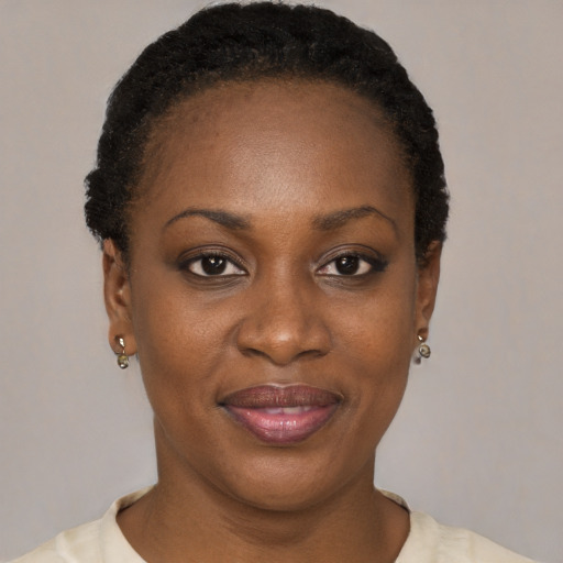 Joyful black adult female with short  black hair and brown eyes