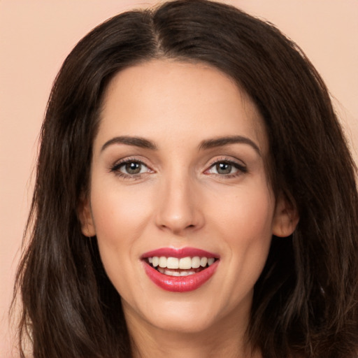 Joyful white young-adult female with long  brown hair and brown eyes