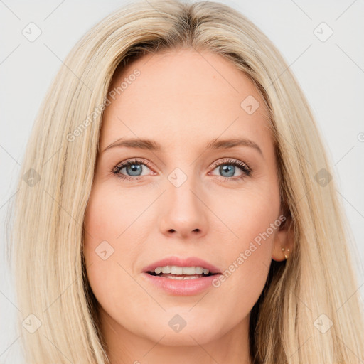 Joyful white young-adult female with long  brown hair and blue eyes