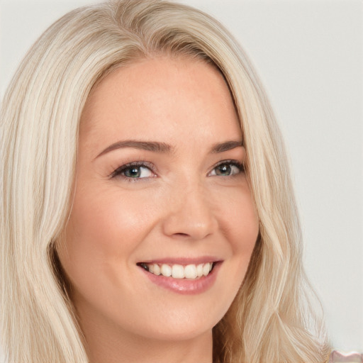 Joyful white young-adult female with long  blond hair and brown eyes