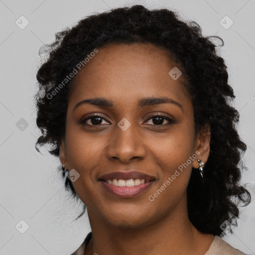 Joyful black young-adult female with long  black hair and brown eyes