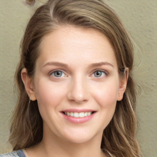 Joyful white young-adult female with medium  brown hair and green eyes