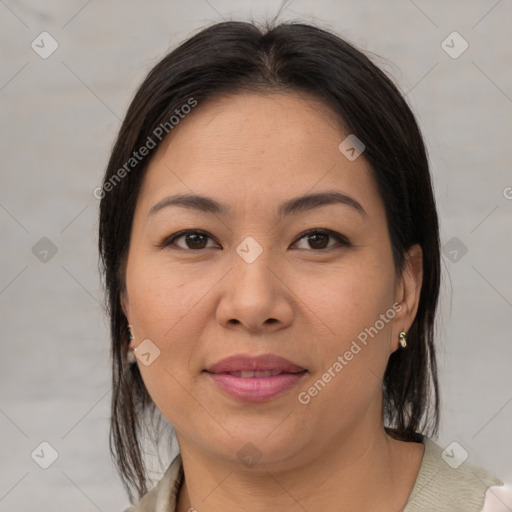 Joyful asian adult female with medium  brown hair and brown eyes