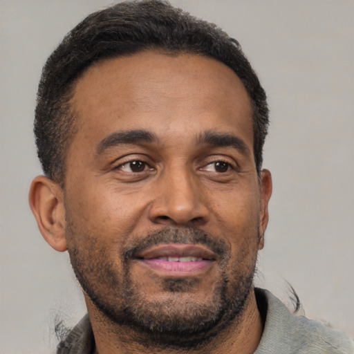 Neutral latino adult male with short  brown hair and brown eyes