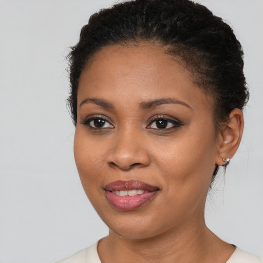 Joyful black young-adult female with short  brown hair and brown eyes