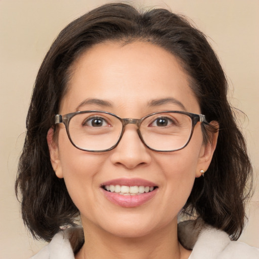 Joyful white adult female with medium  brown hair and brown eyes