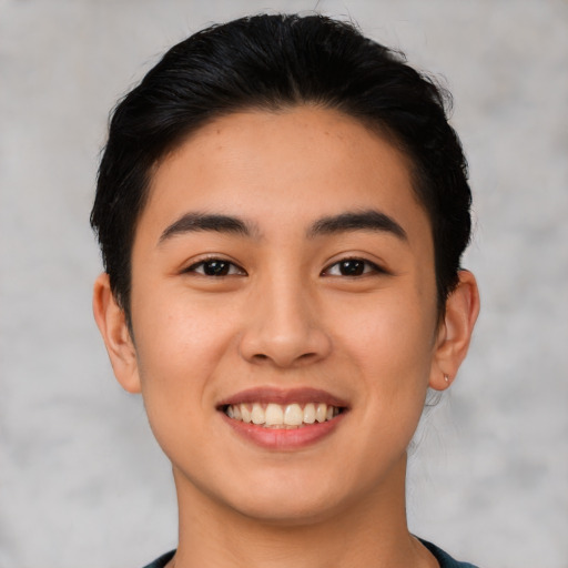 Joyful latino young-adult female with short  black hair and brown eyes