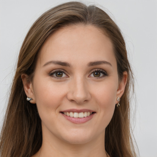 Joyful white young-adult female with long  brown hair and grey eyes