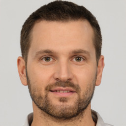 Joyful white adult male with short  brown hair and brown eyes