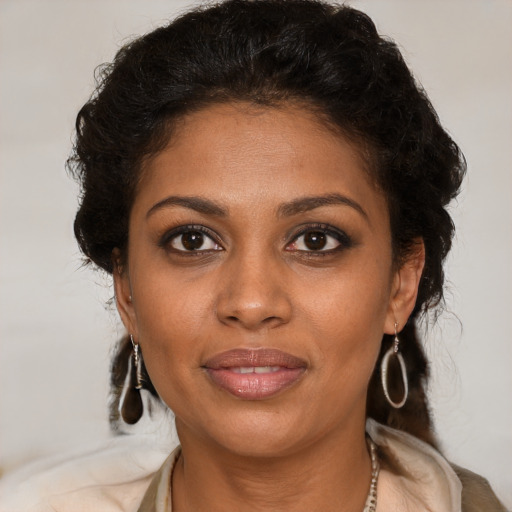 Joyful black young-adult female with medium  brown hair and brown eyes