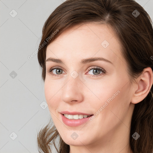 Joyful white young-adult female with long  brown hair and blue eyes