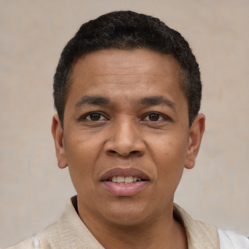 Joyful latino adult male with short  black hair and brown eyes
