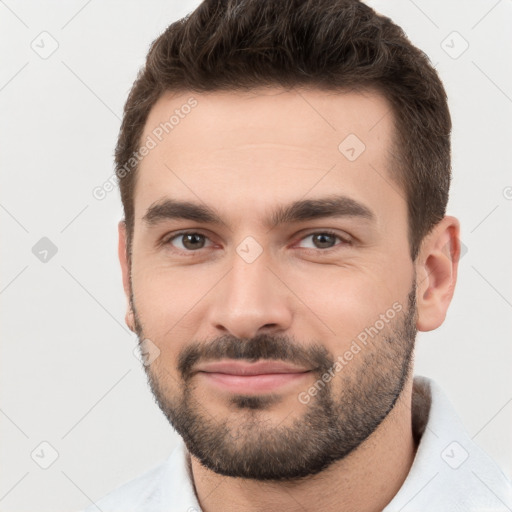 Joyful white young-adult male with short  brown hair and brown eyes