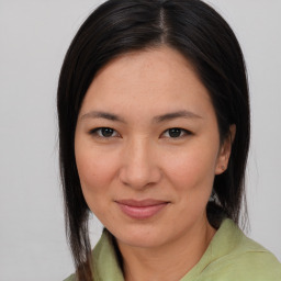 Joyful asian young-adult female with medium  brown hair and brown eyes