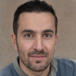 Joyful white adult male with short  brown hair and brown eyes