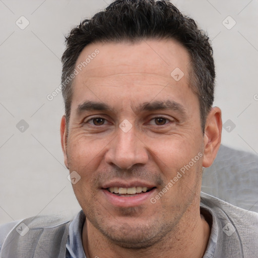 Joyful white adult male with short  black hair and brown eyes