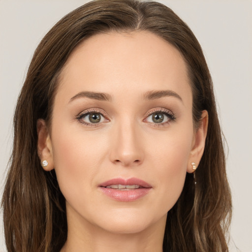 Joyful white young-adult female with long  brown hair and grey eyes