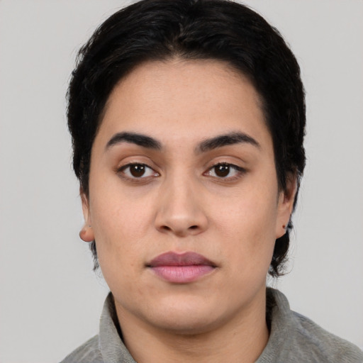 Neutral white young-adult female with short  black hair and brown eyes