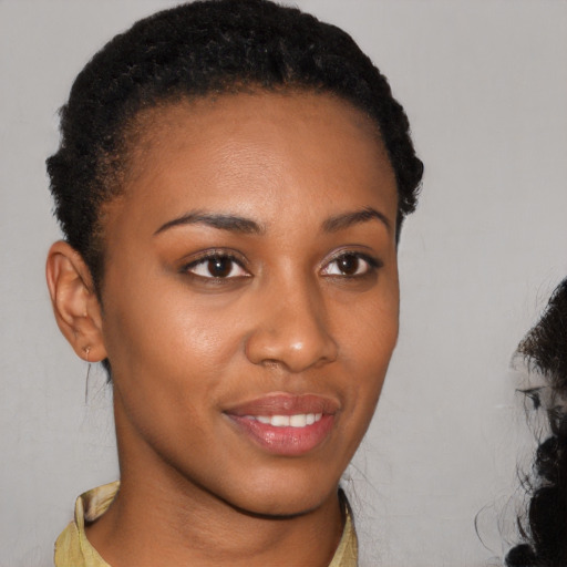 Joyful black young-adult female with short  brown hair and brown eyes