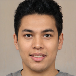 Joyful latino young-adult male with short  brown hair and brown eyes