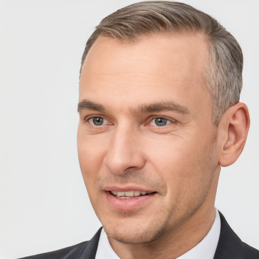 Joyful white adult male with short  brown hair and brown eyes