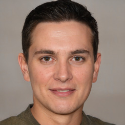 Joyful white adult male with short  brown hair and brown eyes