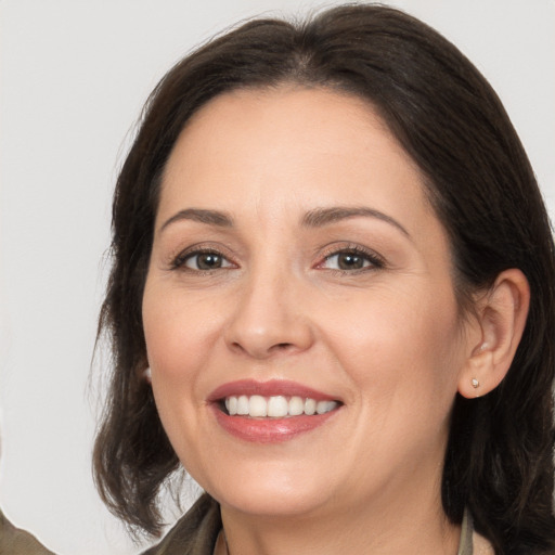 Joyful white adult female with medium  brown hair and brown eyes