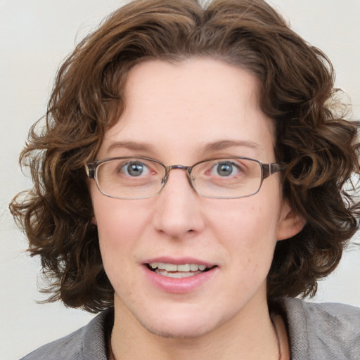 Joyful white adult female with medium  brown hair and blue eyes