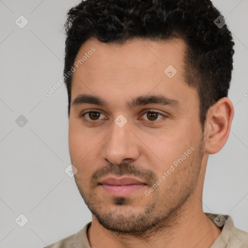 Joyful white young-adult male with short  black hair and brown eyes