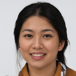 Joyful asian young-adult female with medium  black hair and brown eyes