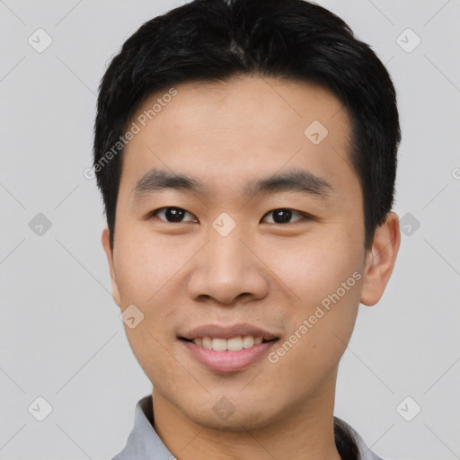 Joyful asian young-adult male with short  black hair and brown eyes