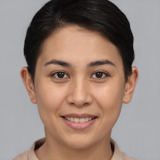 Joyful asian young-adult female with short  brown hair and brown eyes